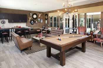 a clubhouse with a pool table and a bar